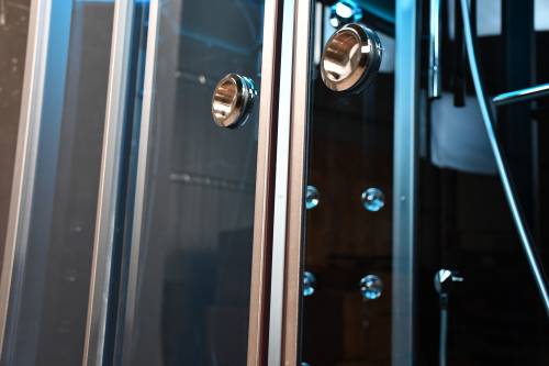 Close-up of a metallic surface with circular knobs and reflections.