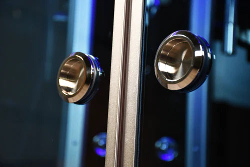Close-up of a guitar with gold knobs on a dark background