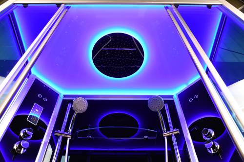 Modern shower cabin with LED lighting and multiple shower heads.