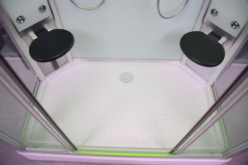 Top view of a shower enclosure with glass panels and black fixtures.