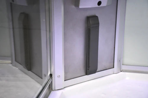 Gray electronic device inside a white enclosure with a clear door