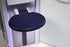 Blue round stool with black seat against a white wall