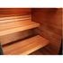 Close-up of a wooden sauna interior with slatted wooden benches and a wood-paneled wall.