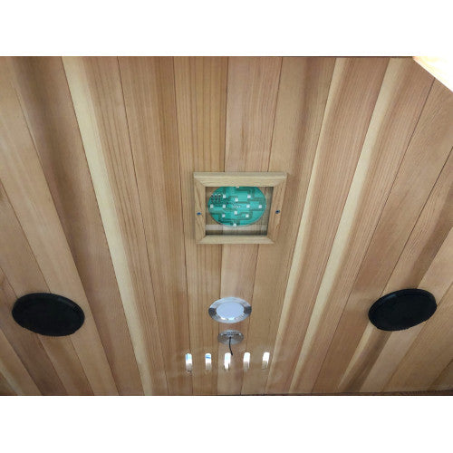 Wooden ceiling with a light fixture and speakers
