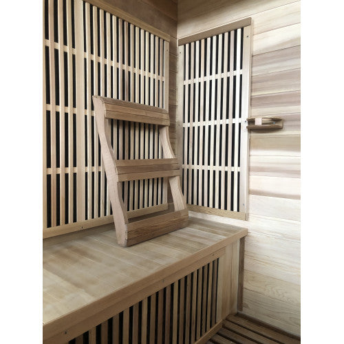 Wooden sauna interior with a bench and lattice windows.