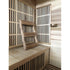Wooden sauna interior with a bench and lattice windows.