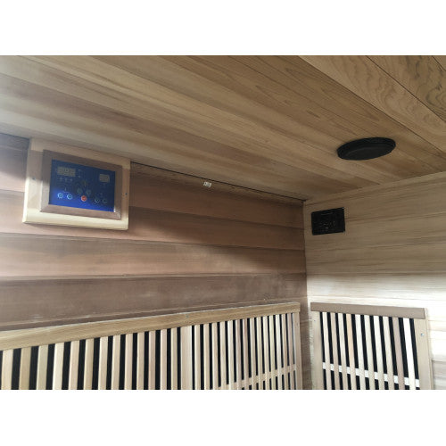 Wooden sauna interior with control panel and exhaust vent.