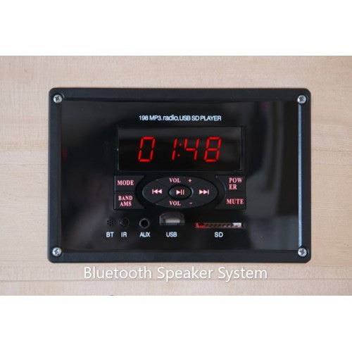 Bluetooth speaker system with digital display and control buttons on a wooden surface.